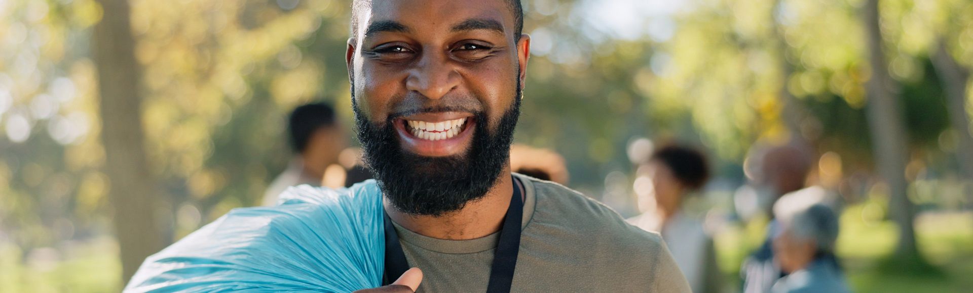 Smiling volunteer engaged in community service and social impact work.