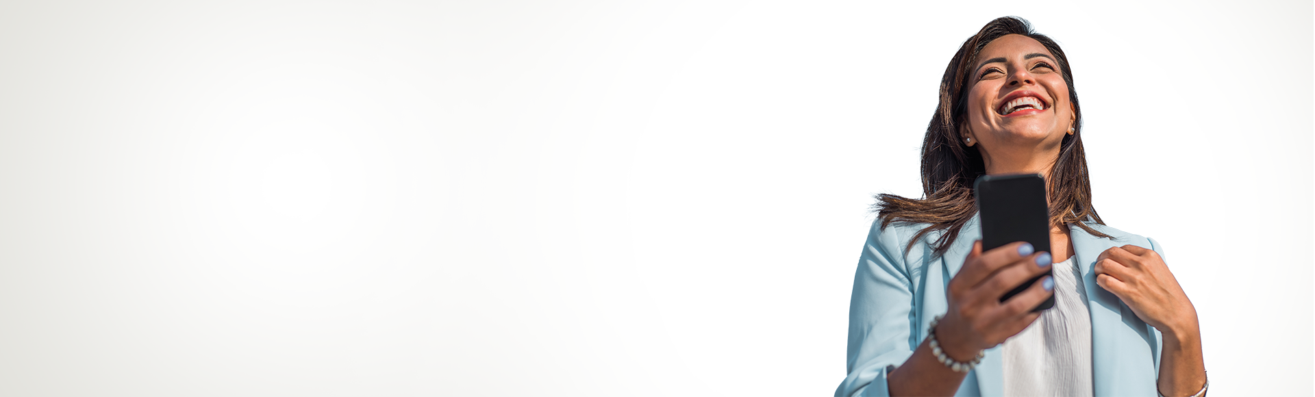 Smiling business woman holding her smartphone