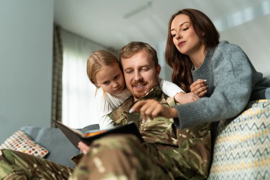 Military service member spending time with family at home.