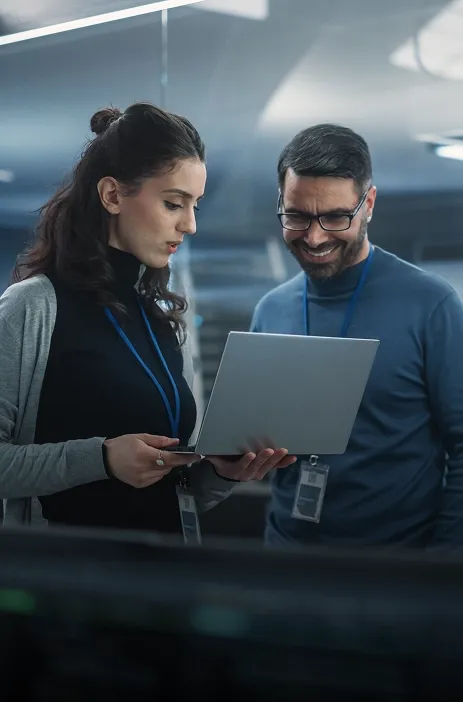 Two professionals reviewing data on a tablet, illustrating intelligent automation collaboration.