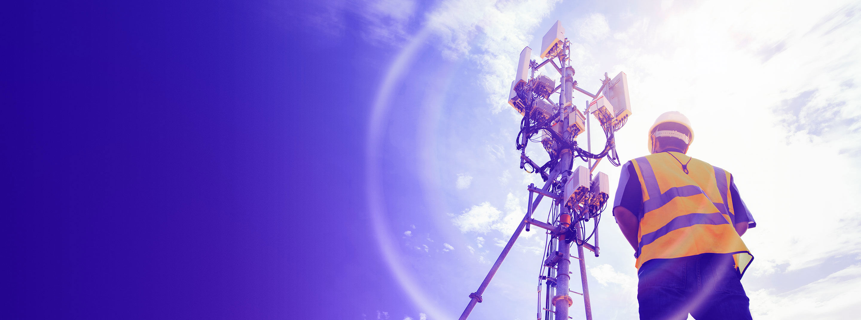 Man working on a transmission tower.