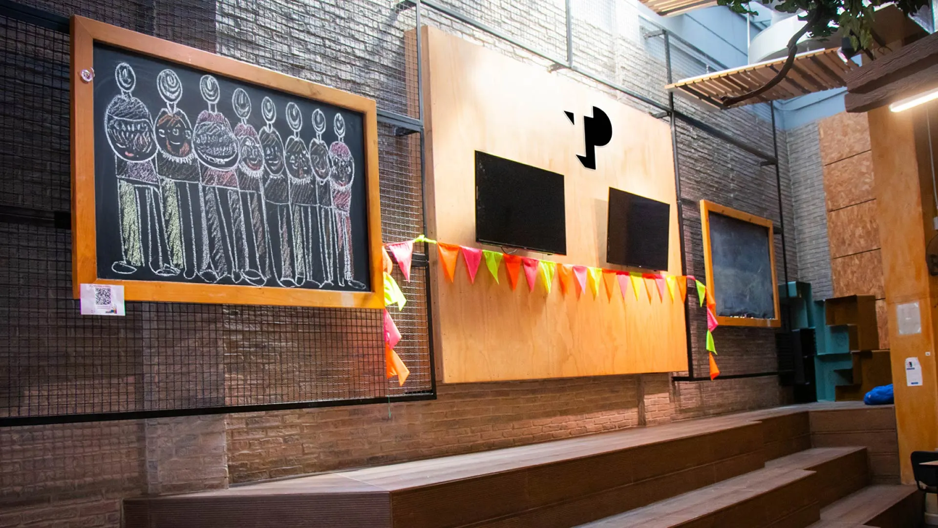 TP office space with chalkboard art, colorful flags, and seating area.