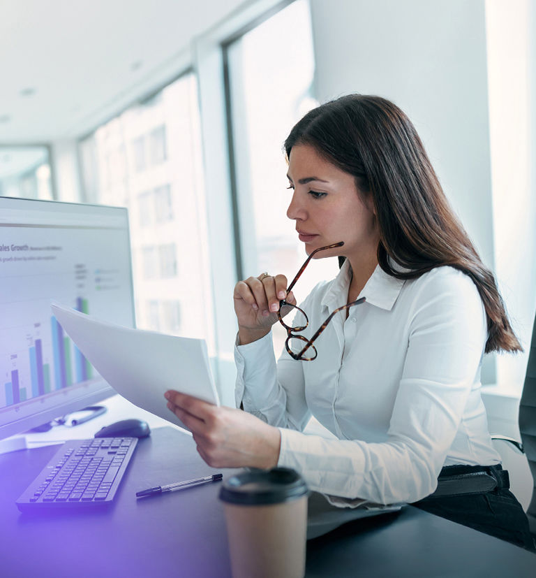 TP RaaS professional reviewing sales performance data on a computer.