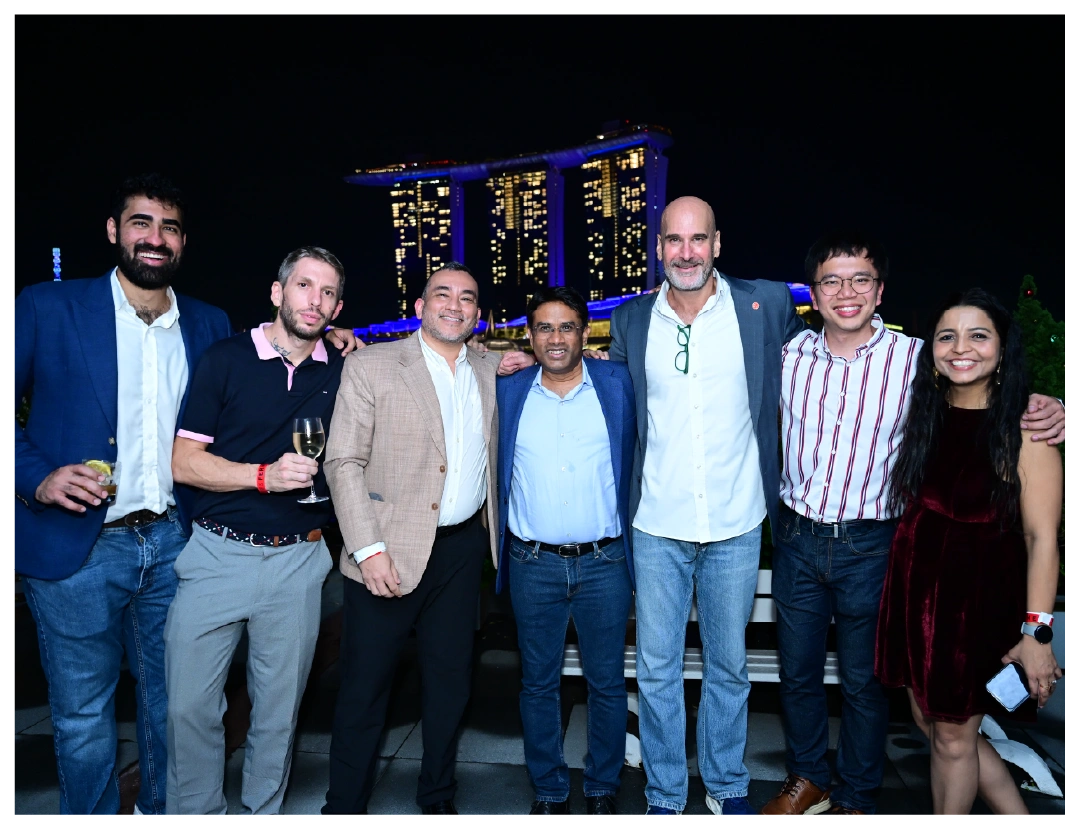 A group of people pose for a fun night photo in Singapore.