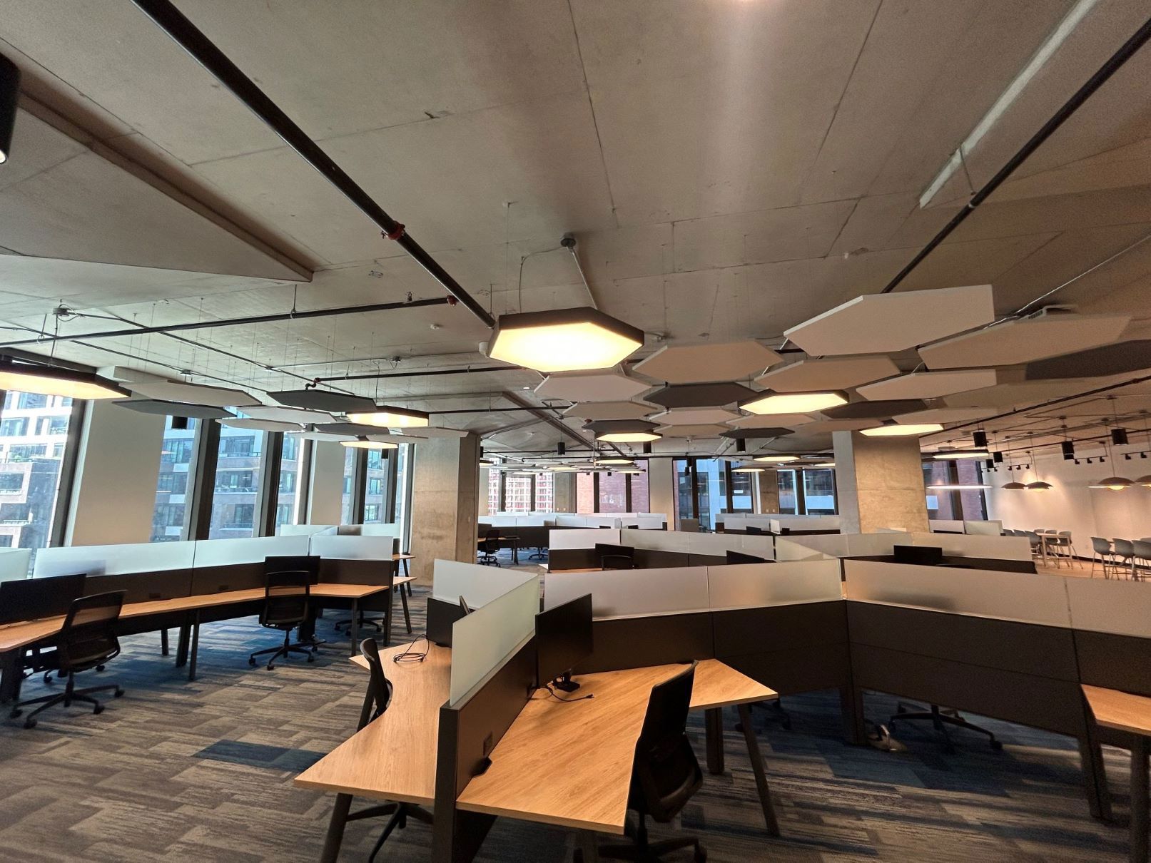TP modern office workspace with empty desks and digital workstations.