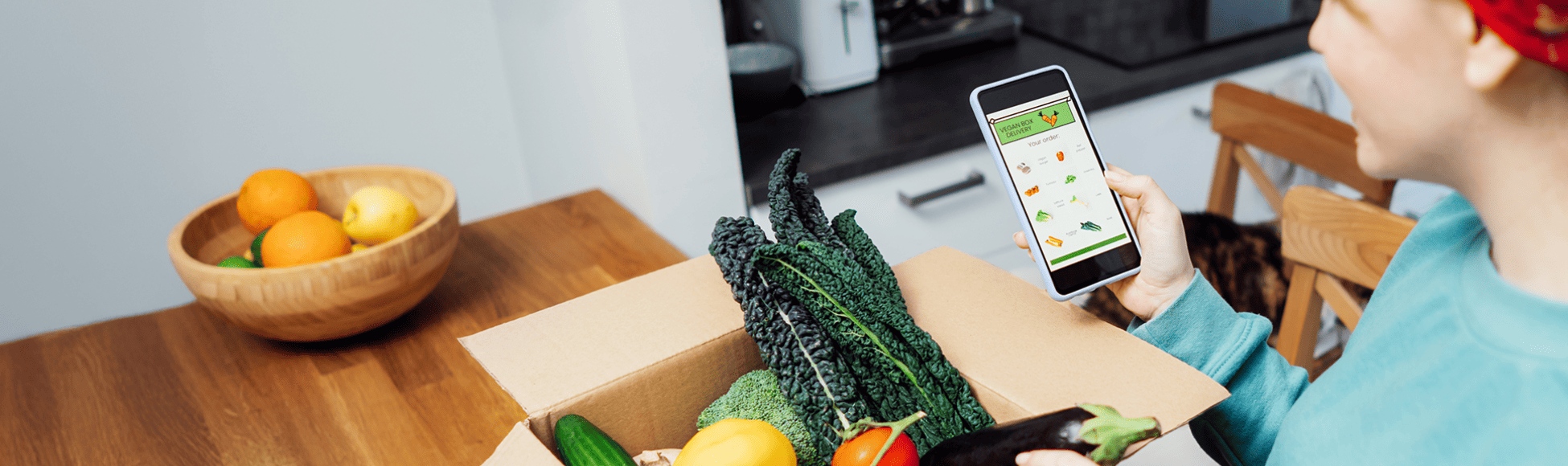 Woman unpacking grocery shopping she ordered through an app