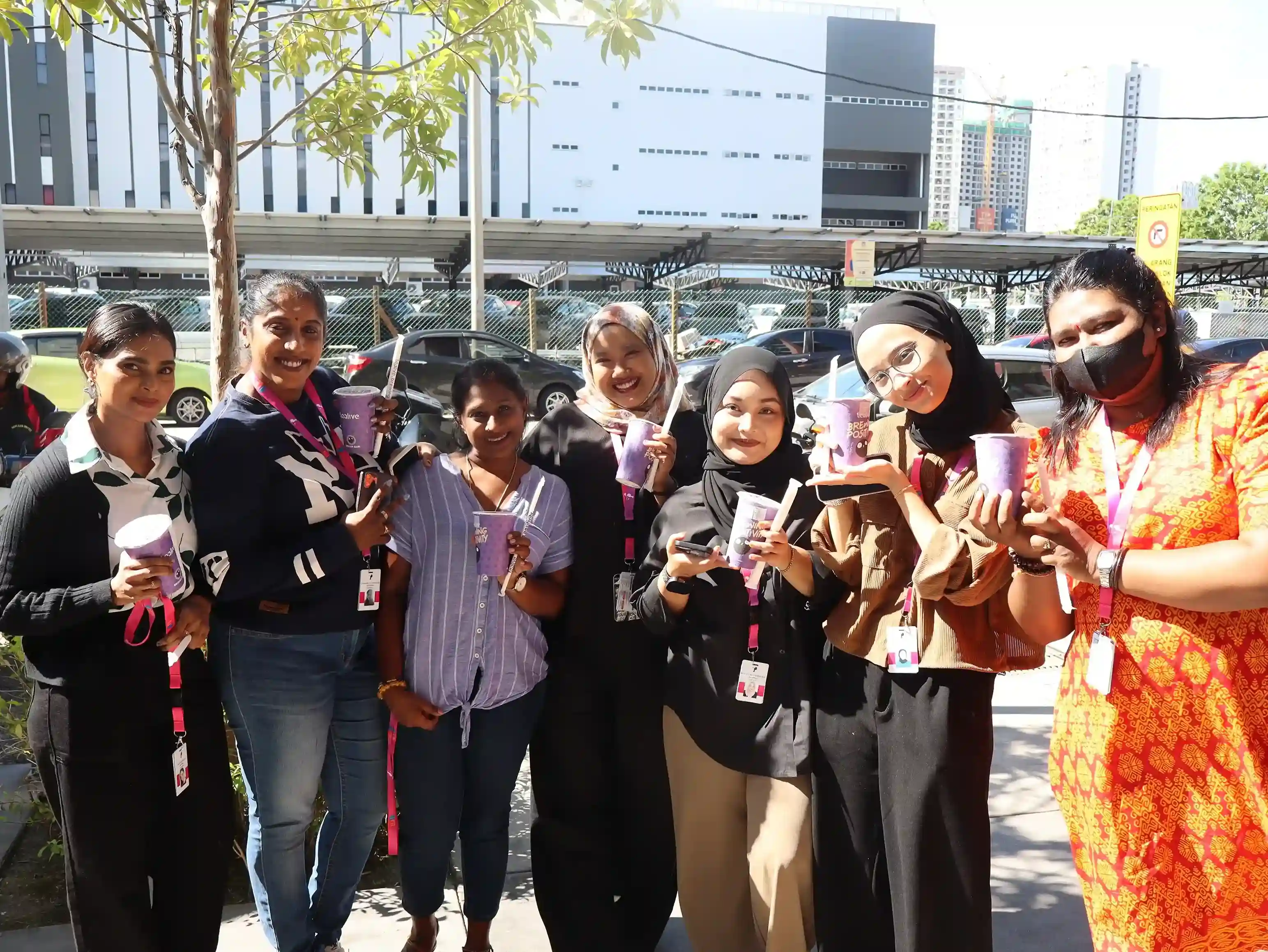 TP employees collaborating and smiling during a team gathering.