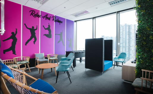 A vibrant, modern office lounge with playful decor and relaxing seating.