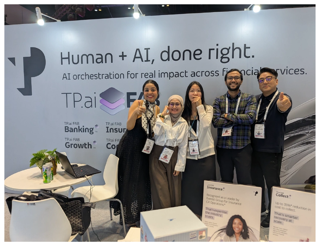 Five people pose at a TP.ai booth promoting AI for financial services.