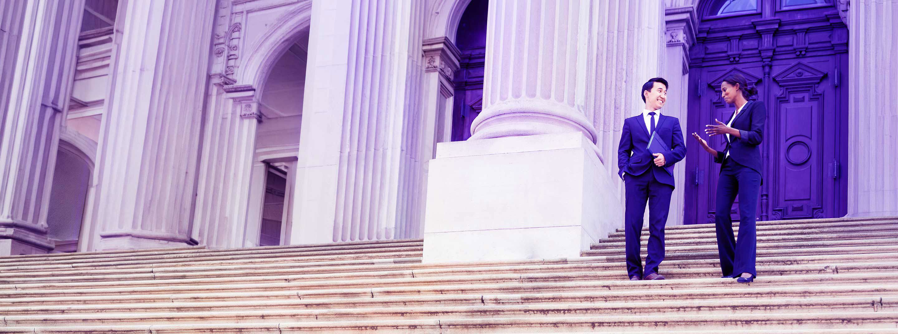 Business couple walking down the stairs.