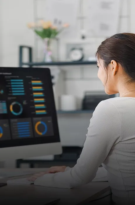 Woman analyzing business dashboards on a computer at TP office.