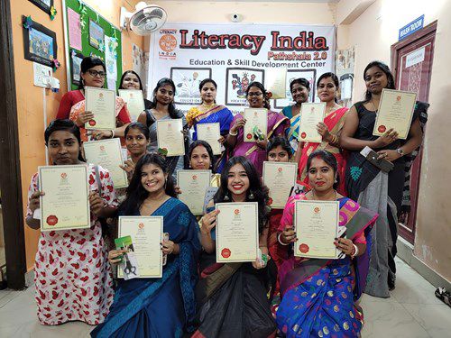 Diverse group of Indian women showing their certificates to the camera