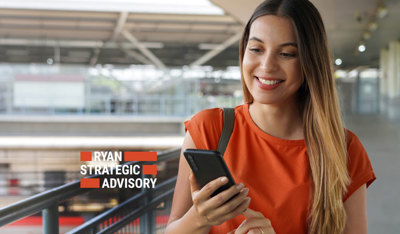 Smiling woman holding a cellphone in a hall