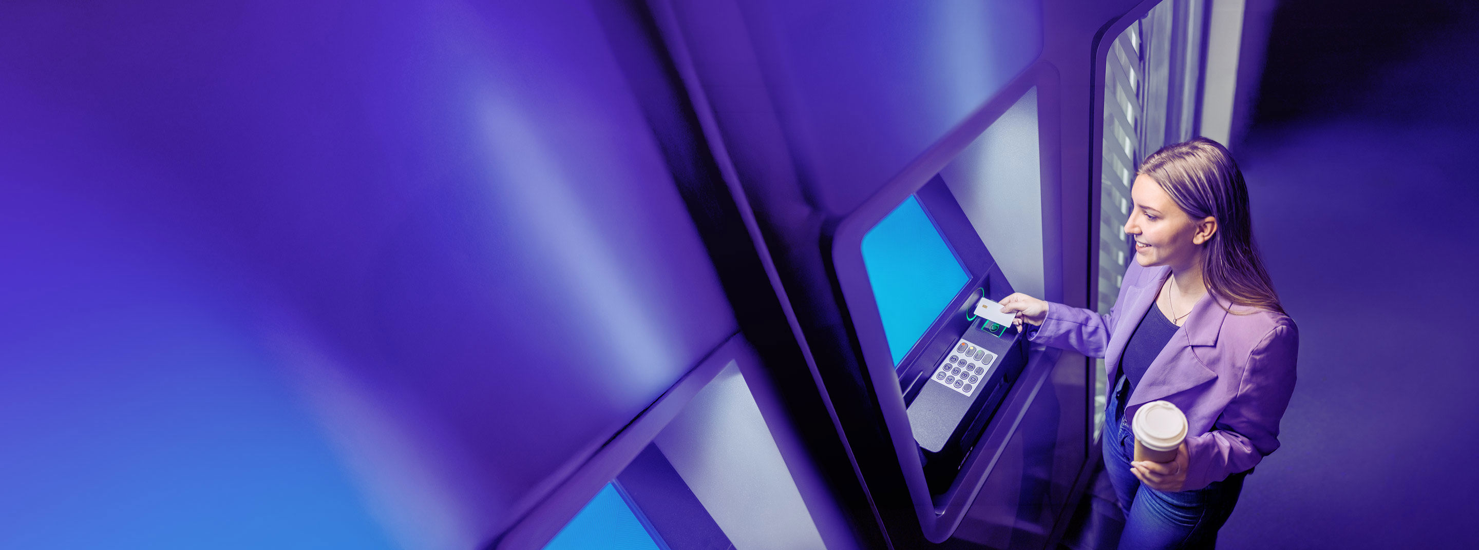 Young woman withdrawing cash from an ATM.