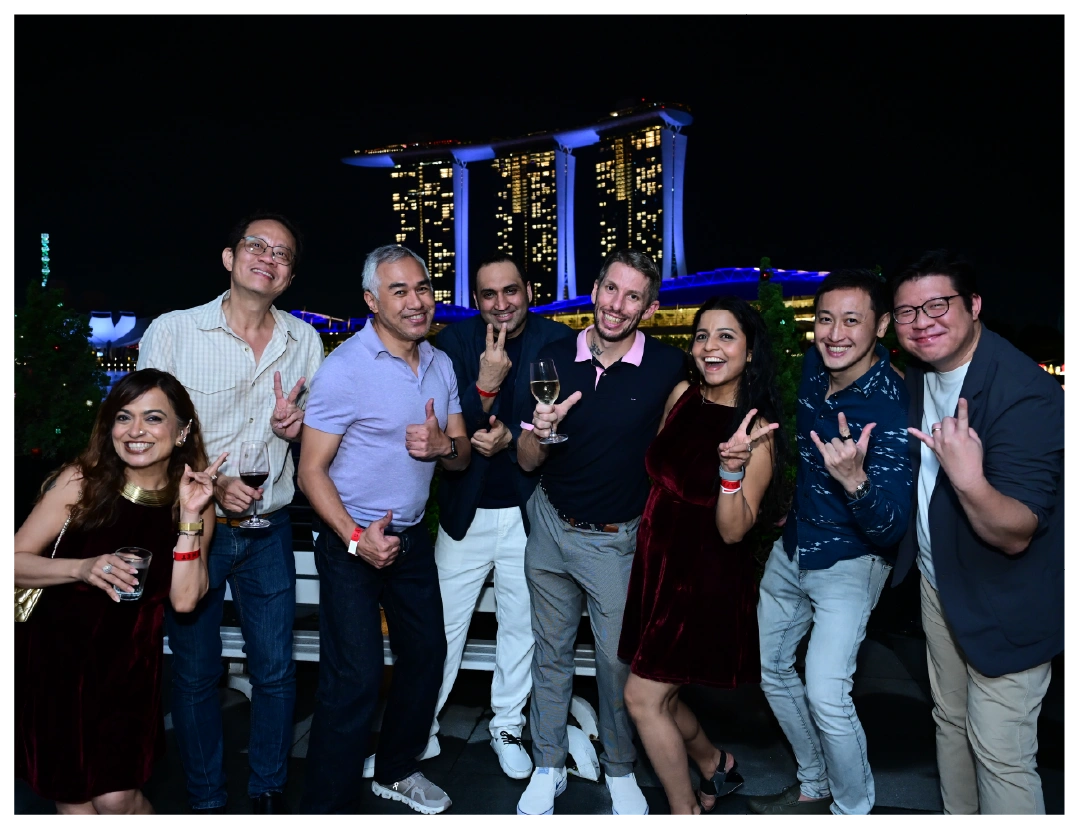 A group of people pose for a fun night photo in Singapore.