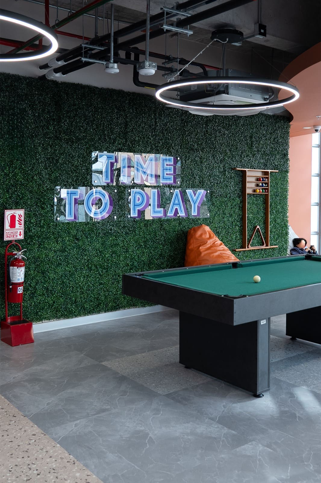 Office with green wall saying time to play