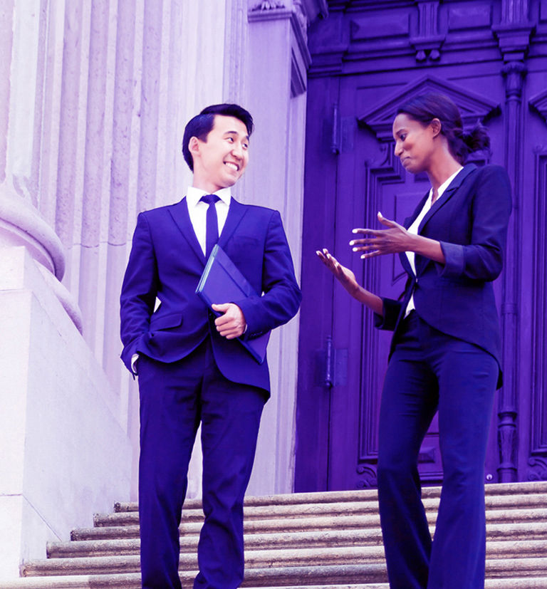 Business couple walking down the stairs.