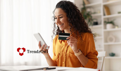 Woman smiling with relief while holding her credit card and phone, feeling safe using services.