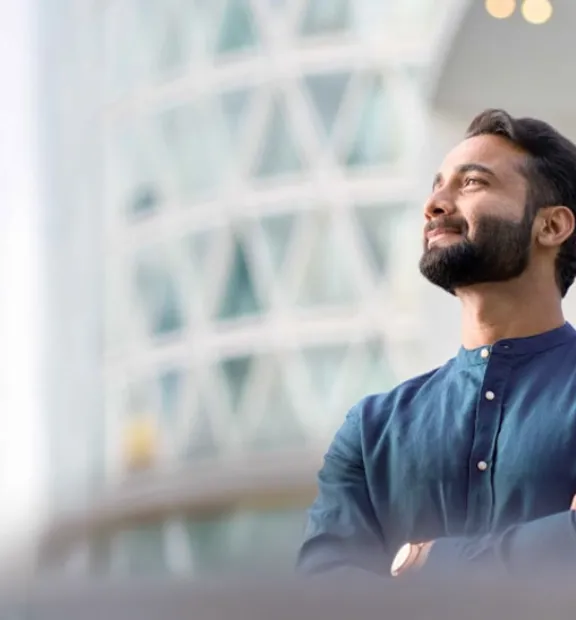 Business professional looking upward with a confident and satisfied expression.