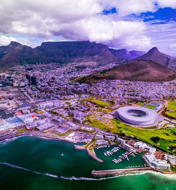 Aerial view of Cape Town, coastline, stadium, and Table Mountain.