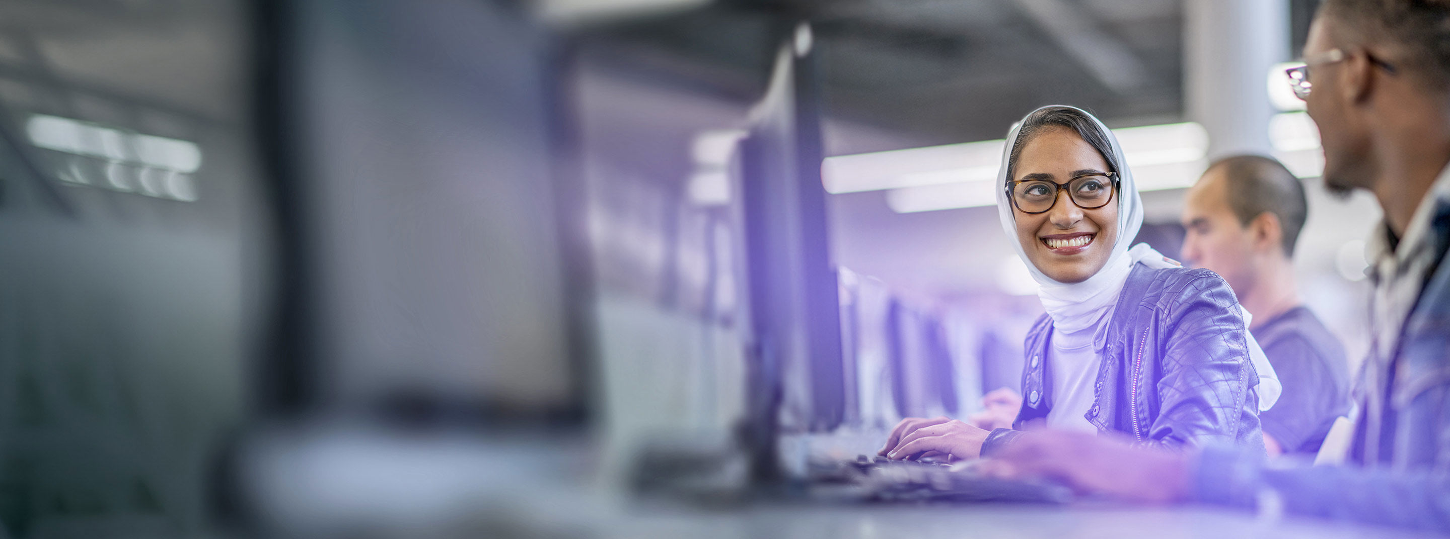 TP multilingual services team member working at a computer in an office.