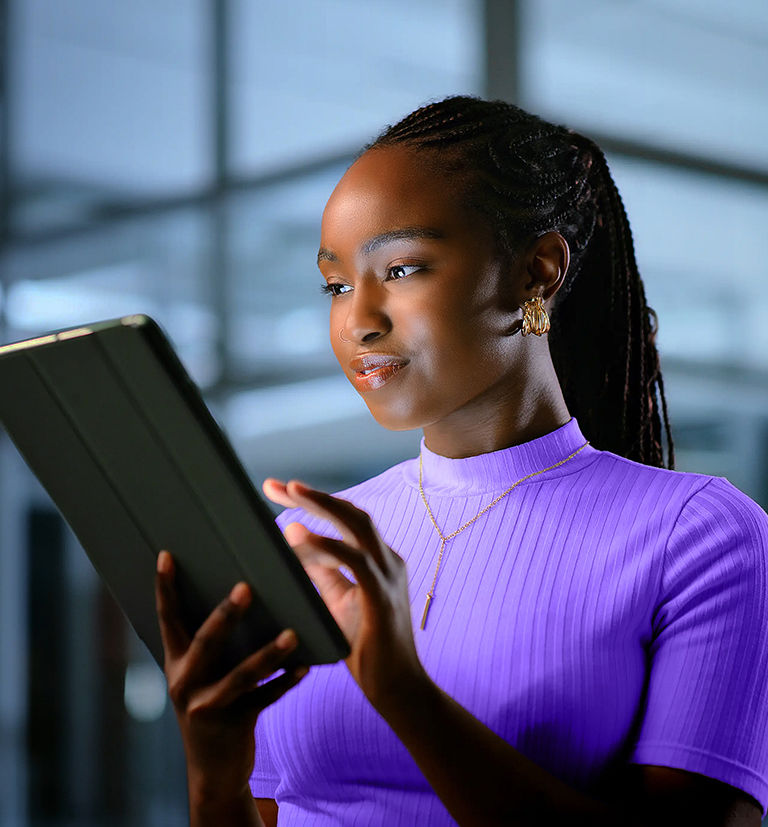 Black businesswoman gaining insights and knowledge through TP content.