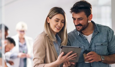 Smiling couple looking at a tablet