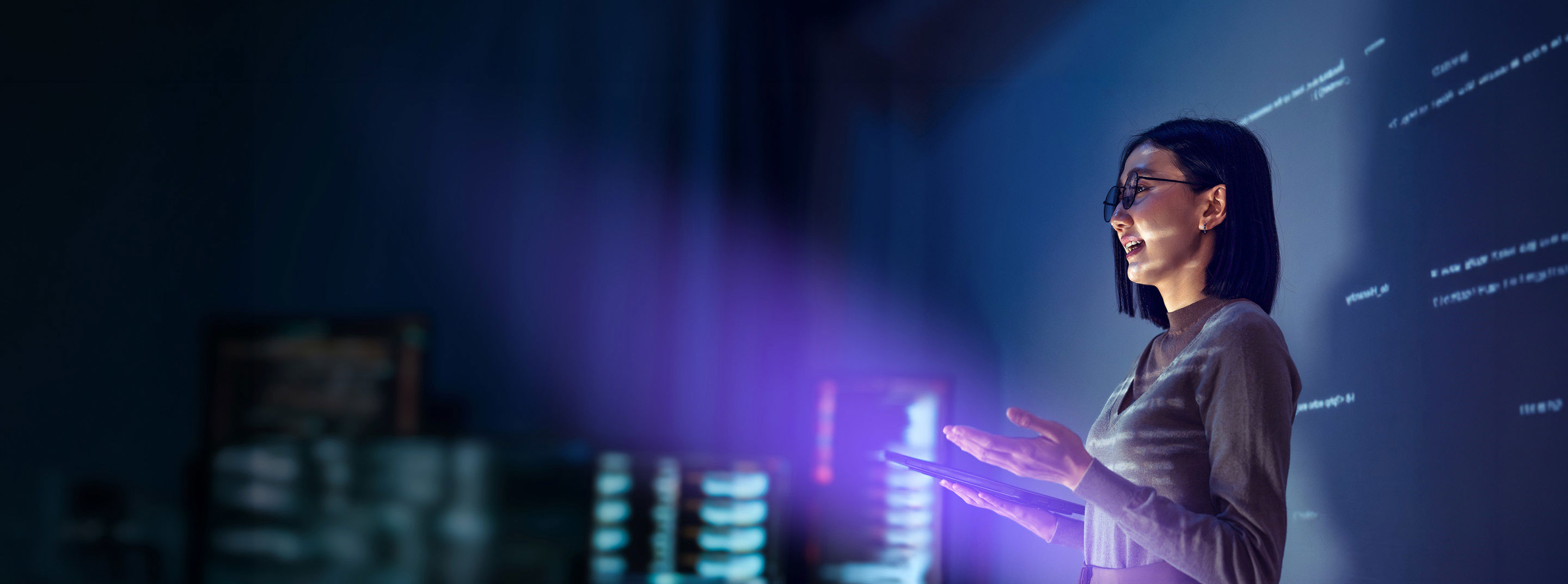 Woman using a tablet during a technology services presentation.