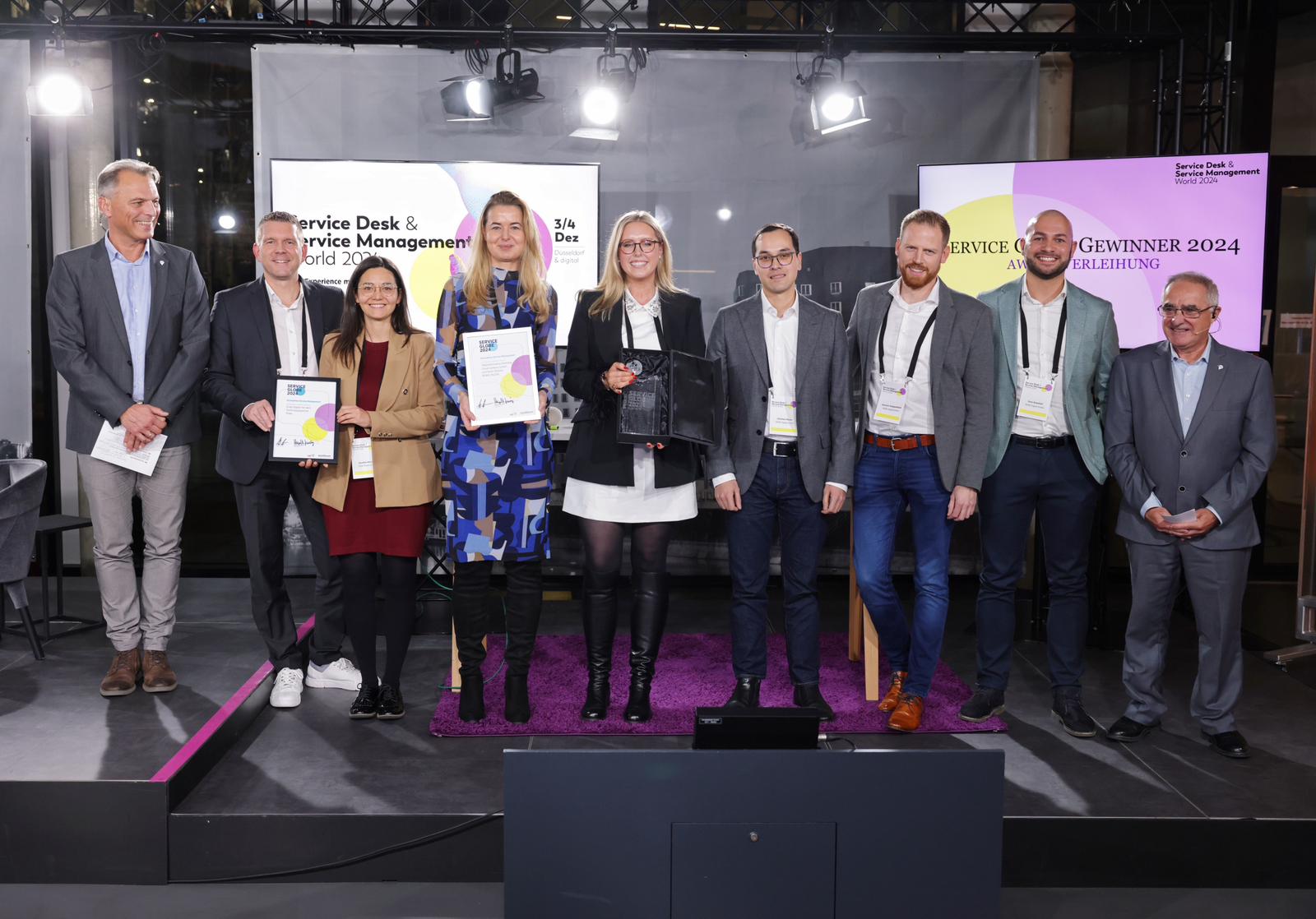 Smiling participants celebrating achievements during a company award ceremony