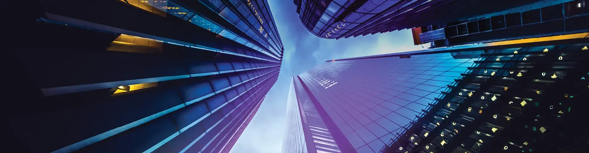 Modern city skyscrapers viewed from below against a blue sky