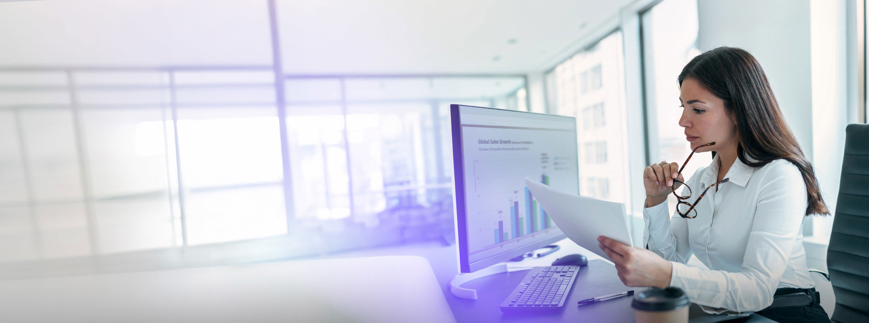 TP RaaS professional reviewing sales performance data on a computer.