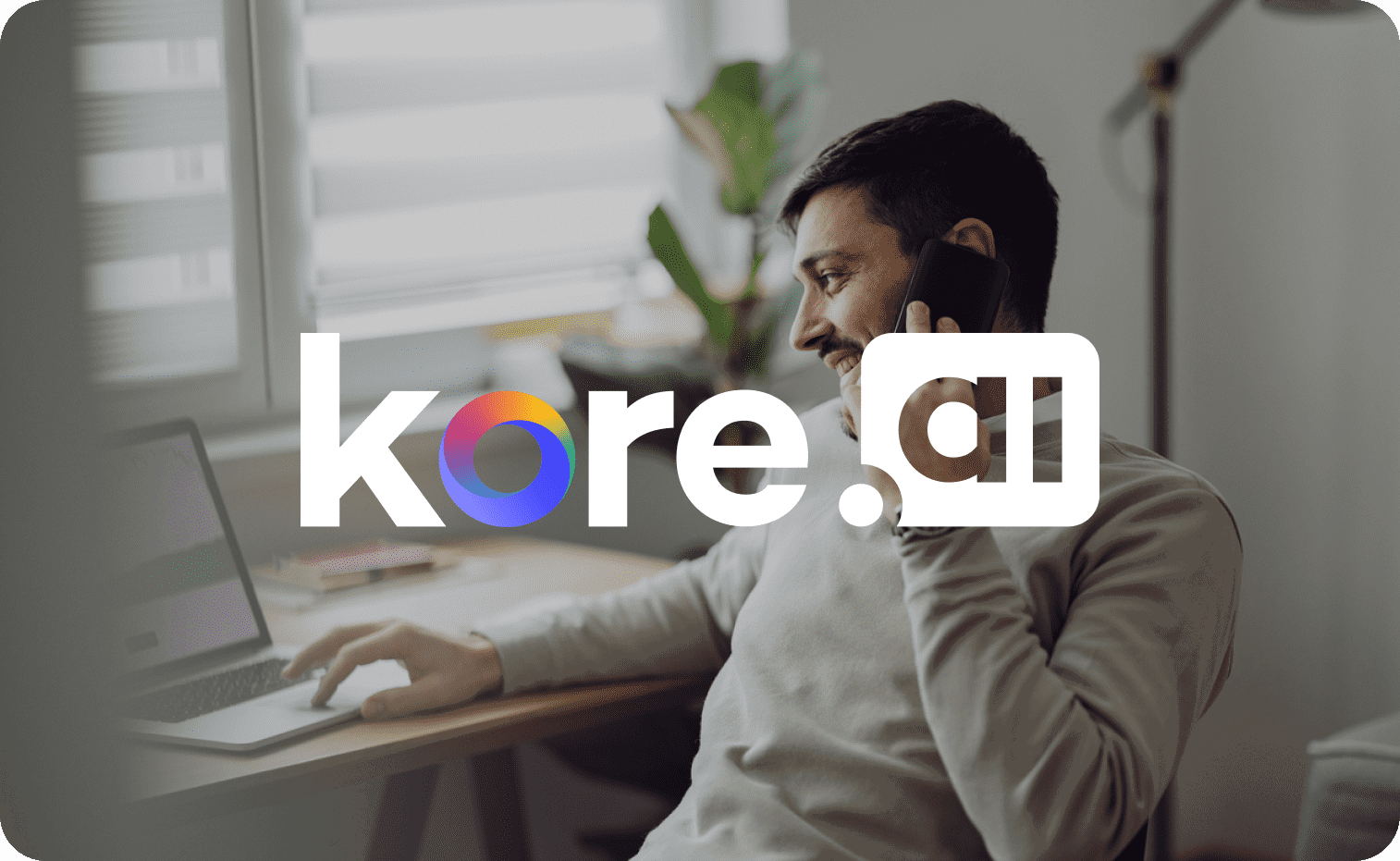 Kore.ai logo in focus with a man talking on the phone in the background