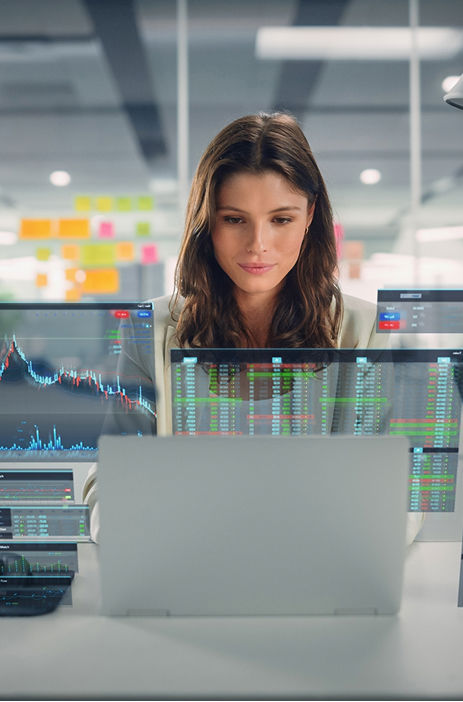 Professional analyzing data on a laptop with digital charts representing AI insights.