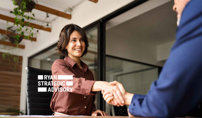 Businesswoman greeting a colleague in a modern office, representing TP’s shoring white paper.