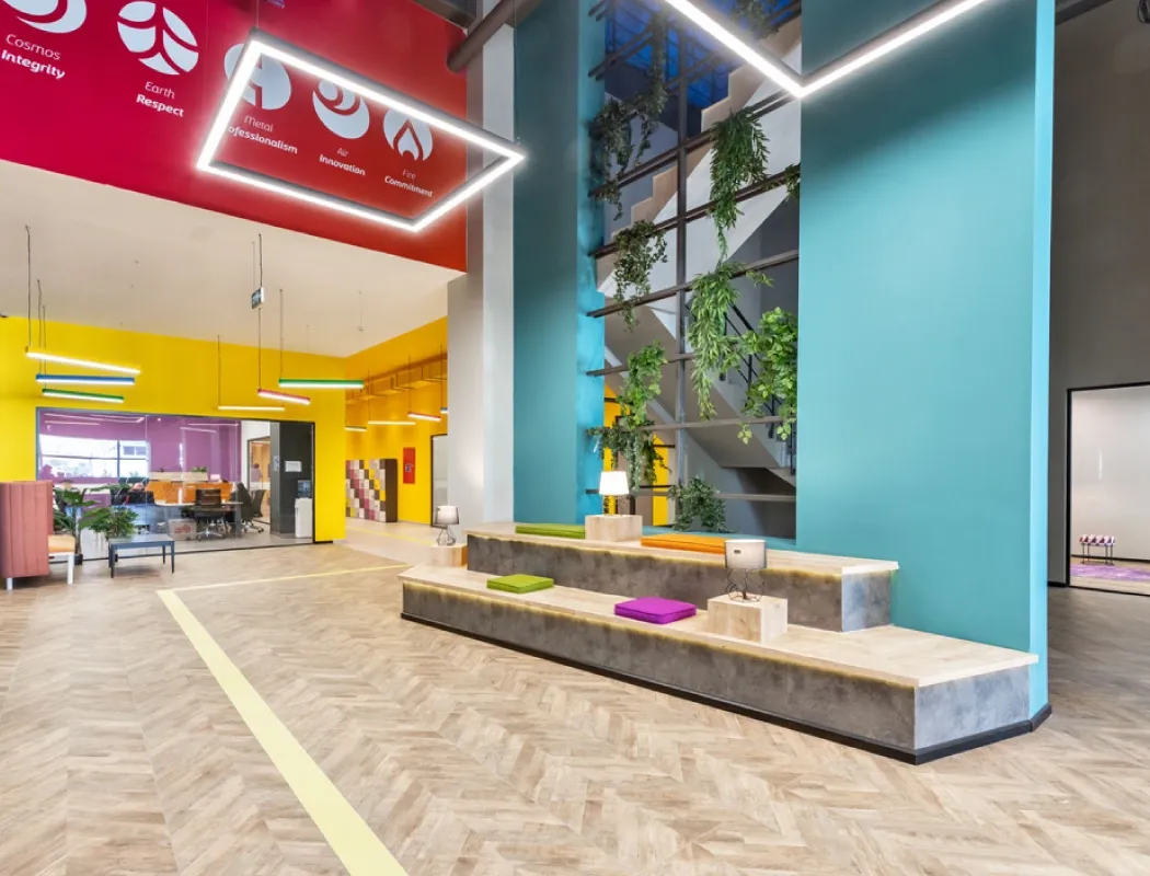 A bright, colorful modern office lobby with playful, open design.