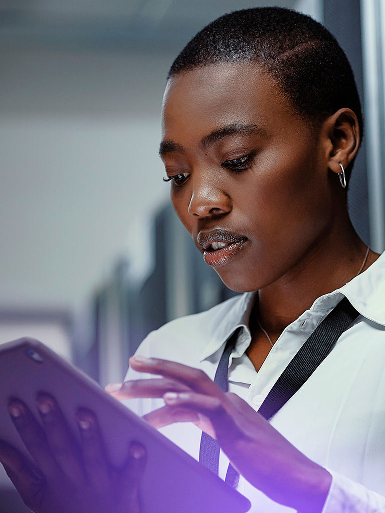 Afro descendant professional working in a modern data center environment.