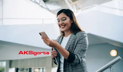 Smiling professional holding a smartphone in TP office corridors, reflecting innovation and empathy.